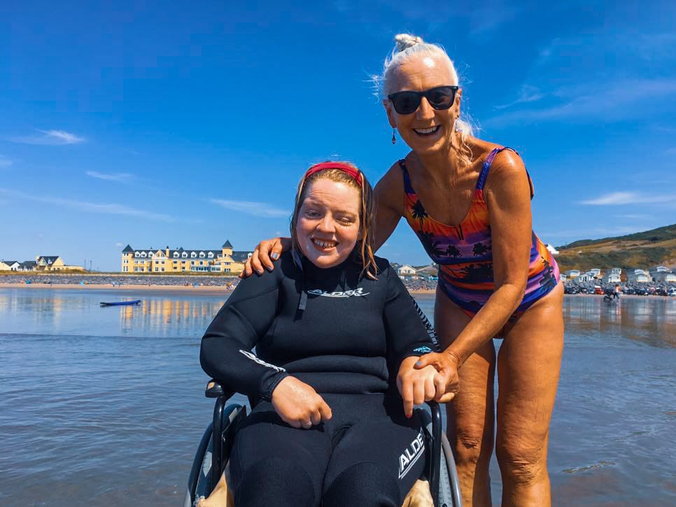 Wheelchair student smiling for the camera during inclusive surf lesson
